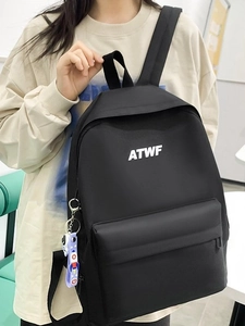 Minimalist black nylon backpack with front zipper pocket and ATWF brand logo for daily use