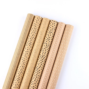 Brown kraft wrapping paper rolls with black heart, stripes and polka dot patterns