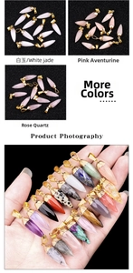 Detailed macro of hexagonal bullet crystal pendants in amethyst and various semi-precious gems