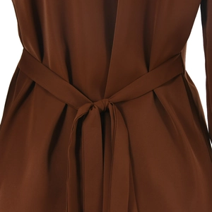 Detail of waist tie on brown satin two-piece set showing silk texture and drapery