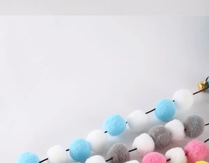 Detailed close-up of colorful plush balls for cat wand toy featuring soft fiber texture