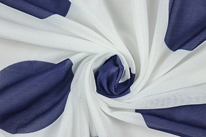 Detailed close-up of breathable mesh fabric with navy blue polka dots on a white base