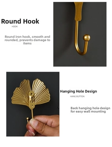 Detail of gold leaf metal hook with rounded tip and wall mounting hole on back
