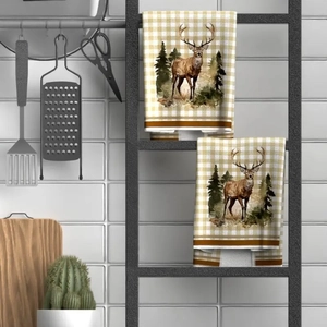 Detail of hanging Christmas microfiber towels with reindeer and pine tree print