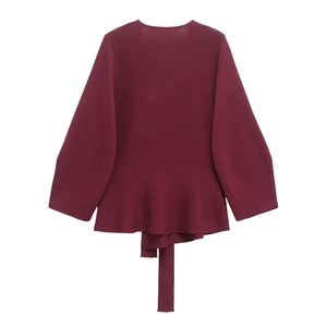 Detailed back view of a burgundy knit sweater with textured fabric and tie hem detail
