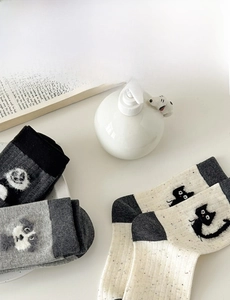 Detail of grey panda and beige cat embroidery on soft cotton crew socks for women