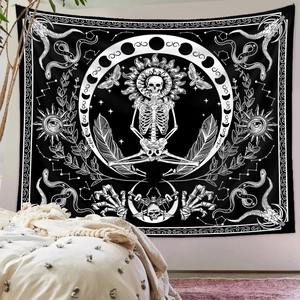 Detail of gothic skeleton tapestry with moon phases and sun motifs on white wall