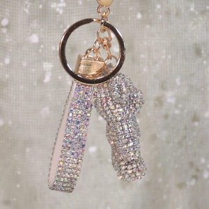 Macro shot of rhinestone bear keychain with glittering lanyard and gold metal clip