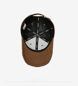 Detail view of the black inner lining and branded stitching on vintage brown baseball cap