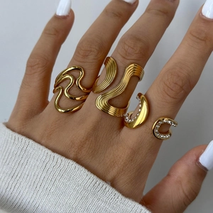 Exaggerated gold stainless steel ring set with wavy bands and sparkling zircon accents