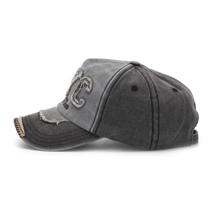 Close-up of vintage NYC embroidery and distressed brim details on a washed cotton cap