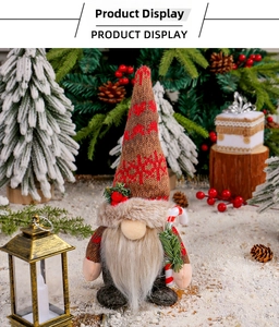 Detailed close-up of Christmas gnome plush with knitted snowflake hat and candy cane accessory