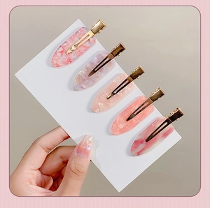 Set of five gold hair clips with pink marble oval acetate resin patterns