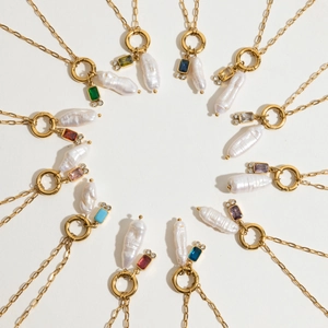 Birthstone pearl necklaces in gold stainless steel arranged in a decorative circle