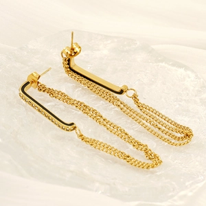 Macro detail of vintage gold fringe earrings with black enamel and small zircons