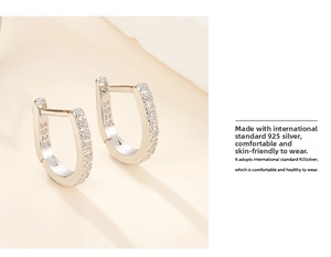 Close-up of S925 sterling silver stamp on minimalist u-shaped pavé cubic zirconia earrings