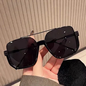 Modern oversized square sunglasses with black frames and metal double bridge design