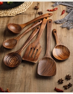 Macro view of six natural teak wood kitchen utensils set with authentic wood grain finish