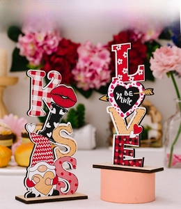 Detail of wooden KISS and LOVE tabletop signs with gnome and heart Valentine's day decor