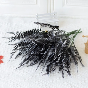 Detailed view of artificial Boston fern leaves with realistic textures on a wooden bench