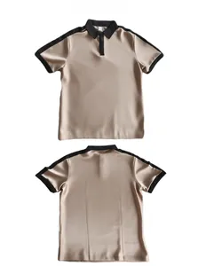Detail of champagne men polo shirt featuring black contrast collar and silky twill texture