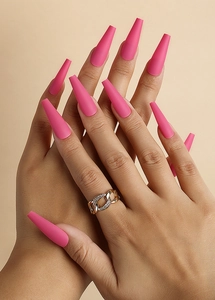 Detailed view of long pink matte coffin press-on nails on hands with a smooth finish