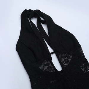 Detail view of black lace halter jumpsuit featuring hollow-out design and floral texture
