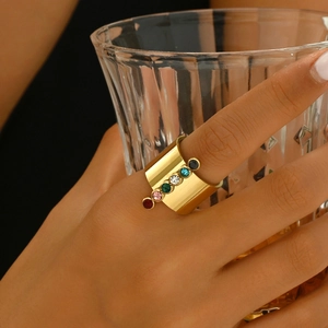 Polished gold wide stainless steel ring with colorful rainbow zircons on finger