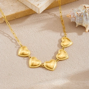 Minimalist gold-plated stainless steel necklace with heart-shaped link charms on marble