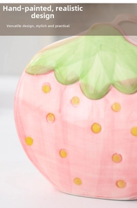 Close-up of pink ceramic strawberry holder with hand-painted seeds and glossy finish