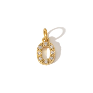 Macro detail of a 316L gold-plated PVD stainless steel letter O pendant with zircon stones