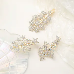 Detailed close-up of crystal star and flower hair clips on a soft textured background