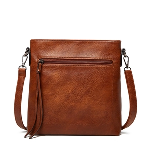 Brown vintage faux leather tote bag with front zipper pocket and long tassels on white background