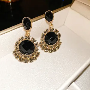 Vintage black and gold flower earrings with silver needle and gray crystal accents