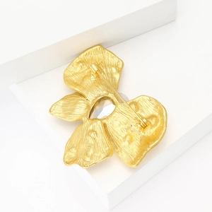Detail view of the vintage matte gold butterfly brooch back showing pin and gemstone