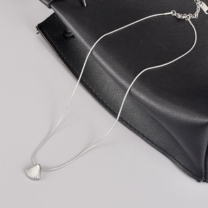 Silver shell pendant necklace with thin snake chain in ocean style on black leather