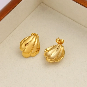 Bohemian gold shell stud earrings in a jewelry box for a summer vacation look