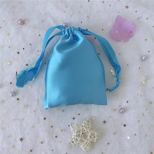 Detail view of light blue satin drawstring pouch for jewelry and gift packaging
