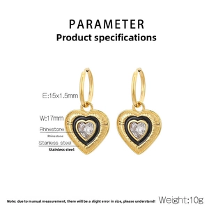 Macro detail of 18K gold plated heart earrings with black enamel and white rhinestones