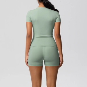Detail of sage green yoga set showing high-waist stretch fabric and slim-fit back design