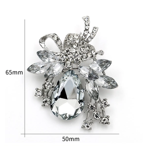 Detailed size view of silver floral brooch with crystals measuring 65mm by 50mm