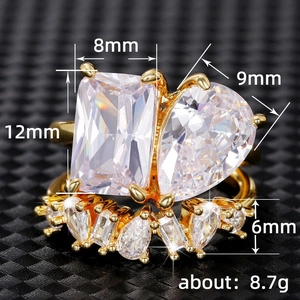Golden teardrop and emerald cut double stone ring with sparkling pavé set crystals