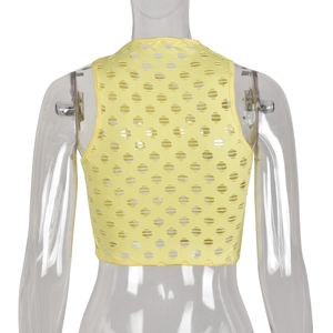 Detail view of yellow crop top with circular hollow knit pattern on a model back