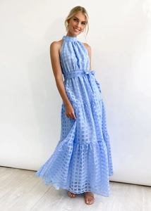 Detail of light blue plaid halter dress featuring a belted waist and tiered skirt layers