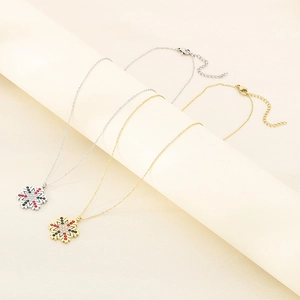 Detail of silver and gold snowflake pendants with colorful rhinestones on display