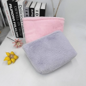 Macro shot of fluffy pink and lavender plush bags with soft texture and floral accents