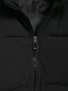 Close-up of durable metal zipper and quilted synthetic fabric texture on black vest
