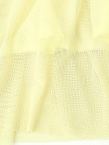 Macro detail of breathable light yellow mesh fabric showing fine texture and fiber weaving