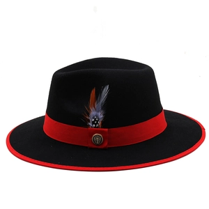 Detail of red bound brim on black fedora with ribbon, feather and anchor badge