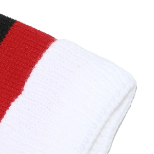 Detailed close-up of chunky ribbed knit texture on the red and white festive holiday scarf